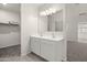Bathroom featuring double sinks with a large mirror, carpeted floors, and easy access to a closet at 1343 W Hess Ave, Coolidge, AZ 85128