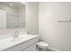 Bathroom featuring a vanity sink, a toilet, a mirror, and a shower over bath at 1343 W Hess Ave, Coolidge, AZ 85128