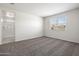 A bright bedroom features carpet, a window for natural light, and an ensuite bathroom at 1343 W Hess Ave, Coolidge, AZ 85128