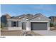Charming single-story home with a two-car garage, neutral color palette and desert landscaping at 1343 W Hess Ave, Coolidge, AZ 85128