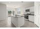 The kitchen features white cabinets, stainless steel appliances and a central island for meal prep and entertaining at 1343 W Hess Ave, Coolidge, AZ 85128