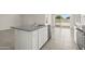 Kitchen island features granite countertops, white cabinets and stainless steel appliances at 1343 W Hess Ave, Coolidge, AZ 85128