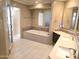 Luxurious bathroom features dual sinks, a soaking tub, and modern tile at 1348 E Los Arboles Dr, Tempe, AZ 85284