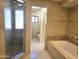 Beautiful bathroom featuring a glass shower and luxurious soaking tub at 1348 E Los Arboles Dr, Tempe, AZ 85284