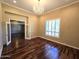 Comfortable bedroom featuring hardwood floors, natural light, and a chandelier at 1348 E Los Arboles Dr, Tempe, AZ 85284