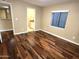 Bedroom with hardwood flooring, neutral walls, and a view to a bathroom at 1348 E Los Arboles Dr, Tempe, AZ 85284