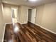 Bright bedroom with hardwood floors, neutral walls, and access to the bathroom at 1348 E Los Arboles Dr, Tempe, AZ 85284