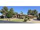 Attractive front view of the property showcasing lush, mature landscaping at 1348 E Los Arboles Dr, Tempe, AZ 85284