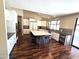 Open kitchen area with white cabinets, large island, stainless steel appliances, and breakfast bar at 1348 E Los Arboles Dr, Tempe, AZ 85284