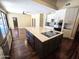 Bright kitchen featuring a large island, stainless steel appliances, and hardwood floors at 1348 E Los Arboles Dr, Tempe, AZ 85284