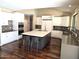 Spacious kitchen with white cabinetry, large island with seating, and stainless steel appliances at 1348 E Los Arboles Dr, Tempe, AZ 85284