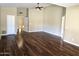 Large living area featuring beautiful hardwood floors, neutral walls, and a modern ceiling fan at 1348 E Los Arboles Dr, Tempe, AZ 85284