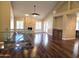Open living room featuring hardwood floors, a stone fireplace, and glass railing at 1348 E Los Arboles Dr, Tempe, AZ 85284