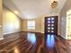 Spacious living room featuring a modern light fixture and hardwood flooring at 1348 E Los Arboles Dr, Tempe, AZ 85284