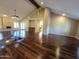 Spacious living room showcasing hardwood floors, fireplace, and access to other rooms at 1348 E Los Arboles Dr, Tempe, AZ 85284