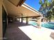 Expansive covered patio area with pool views and outdoor kitchen at 1348 E Los Arboles Dr, Tempe, AZ 85284
