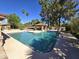 Relaxing pool area features a refreshing pool, mature trees, and outdoor kitchen, perfect for entertaining at 1348 E Los Arboles Dr, Tempe, AZ 85284
