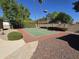 Outdoor tennis court with mature trees provides a private setting for active recreation at 1348 E Los Arboles Dr, Tempe, AZ 85284