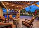 Outdoor living area with a fire pit, string lights, and view of the pool and backyard at 13631 N Canterbury Dr, Phoenix, AZ 85023