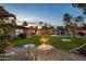 Expansive backyard featuring lush lawn, mature trees, and a sparkling pool at 13631 N Canterbury Dr, Phoenix, AZ 85023