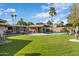 Spacious backyard with a pool, grassy area, and covered patio, perfect for outdoor living at 13631 N Canterbury Dr, Phoenix, AZ 85023