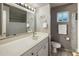 Bathroom featuring gray walls, a single sink vanity, and a large framed mirror at 13631 N Canterbury Dr, Phoenix, AZ 85023