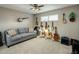 Spare bedroom showcasing a gray sofa and walls decorated with musical instruments, creating a unique and inviting space at 13631 N Canterbury Dr, Phoenix, AZ 85023