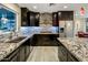 Modern kitchen with dark cabinets, granite countertops, and stainless steel appliances at 13631 N Canterbury Dr, Phoenix, AZ 85023