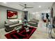 Comfortable living room has contemporary decor, plush sofas, and glass coffee table sitting on a red and black rug at 13631 N Canterbury Dr, Phoenix, AZ 85023