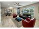 Bright living room featuring neutral tones, a ceiling fan, and large windows at 13631 N Canterbury Dr, Phoenix, AZ 85023