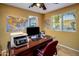Inviting office space featuring a wood desk, a map of the US, and a view of the yard from a side window at 13631 N Canterbury Dr, Phoenix, AZ 85023