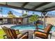 Poolside seating area with a pergola, lounge chairs and view of lush landscaping at 13631 N Canterbury Dr, Phoenix, AZ 85023
