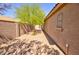 A backyard with a tree, gravel and block fence at 1385 E Martha Dr, Casa Grande, AZ 85122