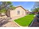 Well-maintained backyard with green grass and a rock border at 1385 E Martha Dr, Casa Grande, AZ 85122