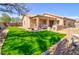 Large backyard features a lush green lawn and covered patio, ideal for outdoor entertaining at 1385 E Martha Dr, Casa Grande, AZ 85122