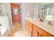 Bright bathroom with dual sinks, wood cabinetry, and a separate tub and shower at 1385 E Martha Dr, Casa Grande, AZ 85122