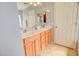 Bright bathroom with dual sinks, wood cabinetry, and a separate tub and shower at 1385 E Martha Dr, Casa Grande, AZ 85122