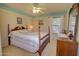 Comfortable bedroom featuring a wood-frame bed, ceiling fan, and ample natural light at 1385 E Martha Dr, Casa Grande, AZ 85122