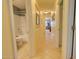 Hallway featuring tile floors, neutral paint colors, and views into the bathroom and other rooms at 1385 E Martha Dr, Casa Grande, AZ 85122