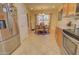 Bright kitchen with stainless steel appliances, granite counters, and a breakfast nook at 1385 E Martha Dr, Casa Grande, AZ 85122