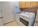 Functional laundry room equipped with a washer, dryer, storage cabinets and a door to the outside at 1385 E Martha Dr, Casa Grande, AZ 85122
