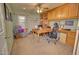 Bright home office with built-in desk, wood cabinets, ceiling fan, and comfortable seating area at 1385 E Martha Dr, Casa Grande, AZ 85122