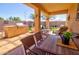 Covered patio with built-in BBQ, outdoor seating, and a view of the landscaped backyard at 1385 E Martha Dr, Casa Grande, AZ 85122