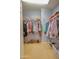 Organized walk-in closet with hanging racks and storage, offering ample storage space at 1385 E Martha Dr, Casa Grande, AZ 85122