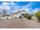 The backyard with a private patio, gravel landscaping, and lovely perimeter bushes at 14241 N 56Th Pl, Scottsdale, AZ 85254