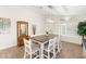 Inviting dining space with a rustic table, seating for six, and a decorative wall mirror at 14241 N 56Th Pl, Scottsdale, AZ 85254