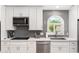 Bright kitchen features gray subway tile, stainless steel appliances, and a large arched window at 14241 N 56Th Pl, Scottsdale, AZ 85254