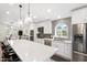 Bright open kitchen featuring modern appliances, center island with seating, and seamless design at 14241 N 56Th Pl, Scottsdale, AZ 85254