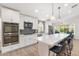 Modern kitchen featuring white cabinets, stainless steel appliances, and a center island with bar seating at 14241 N 56Th Pl, Scottsdale, AZ 85254