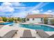 Backyard swimming pool with lounge chairs and outdoor dining under the blue sky at 14241 N 56Th Pl, Scottsdale, AZ 85254